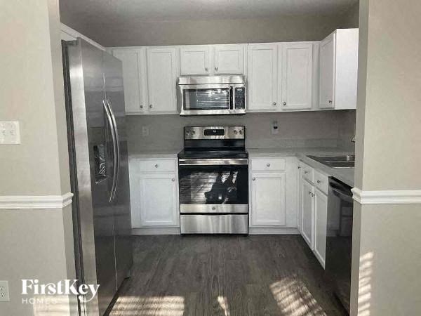 a kitchen with stainless steel appliances and white cabinets