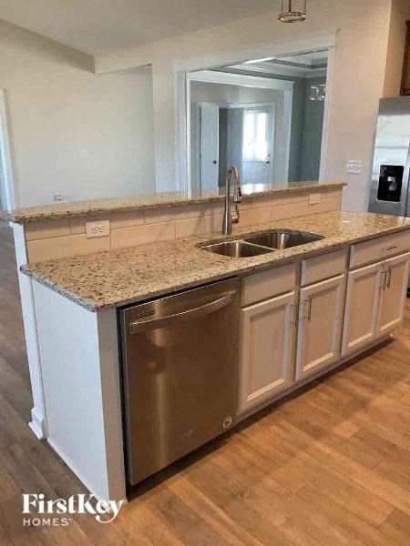 a kitchen with a stainless steel sink and counter top
