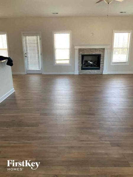 a living room with a hard wood floor and a fireplace