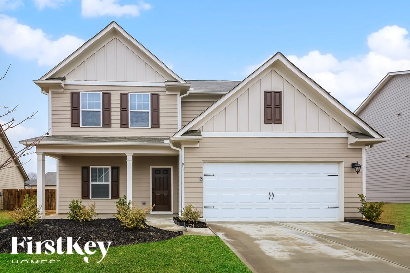 A two-story house with a garage is for sale by FirstKey Homes.
