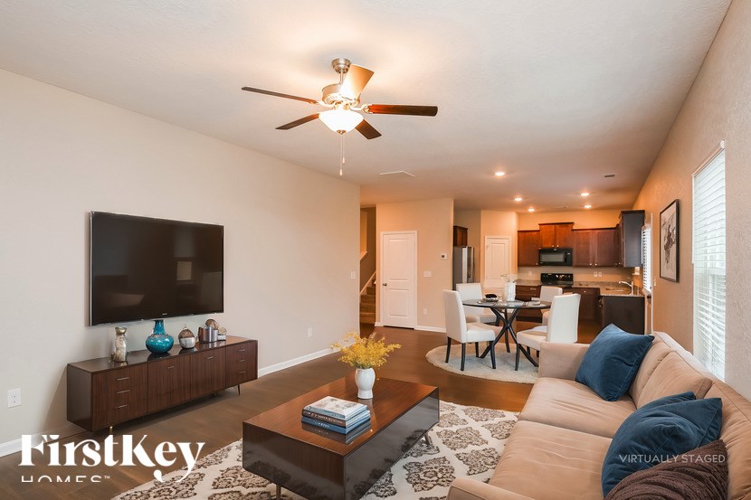 A living room with a brown sofa and a wooden coffee table.
