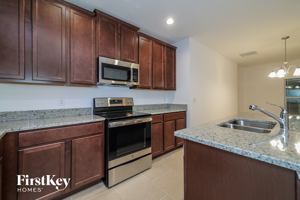 a kitchen with stainless steel appliances and granite counter tops