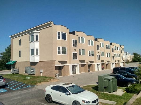 a white car parked in front of an apartment building
