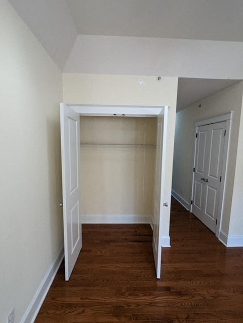 an empty room with a closet and a door