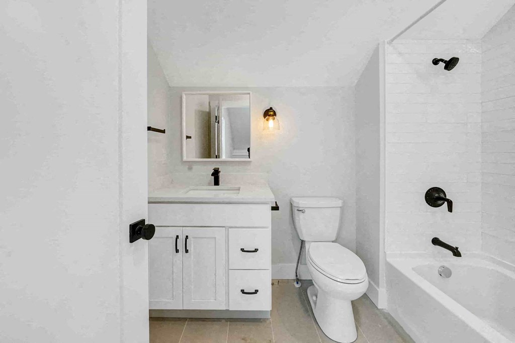 a bathroom with a toilet and a sink and a bath tub