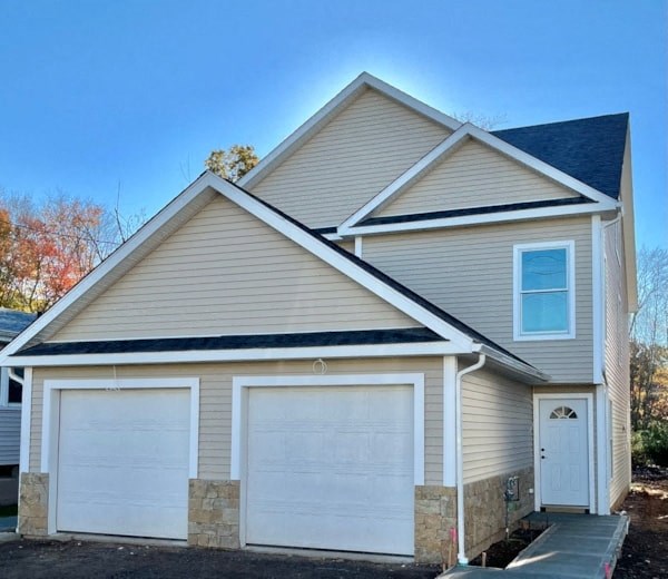 a house with two white garage doors