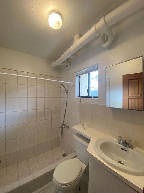 a white bathroom with a sink and a toilet