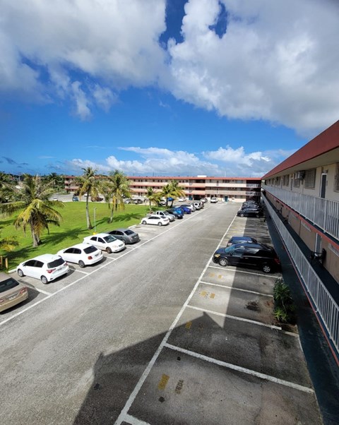 a view of the parking lot from the balcony of a hotel