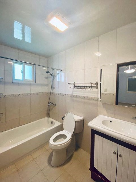 a bathroom with a toilet and a tub and a sink
