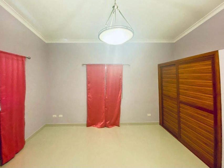 a room with a wardrobe and a red curtain