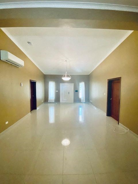 an empty room with a white tile floor and two doors