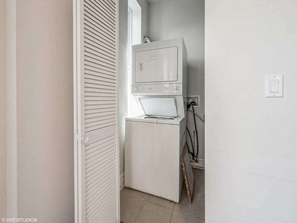 a laundry room with a washing machine and a refrigerator