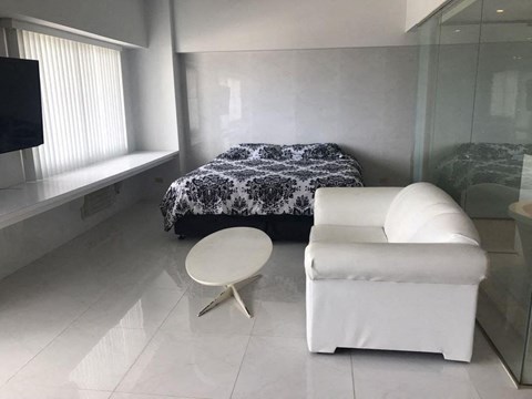 a bedroom with a bed and a chair and a table