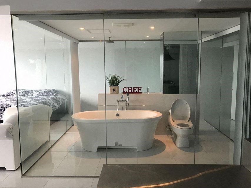 a bathroom with a toilet and a bath tub