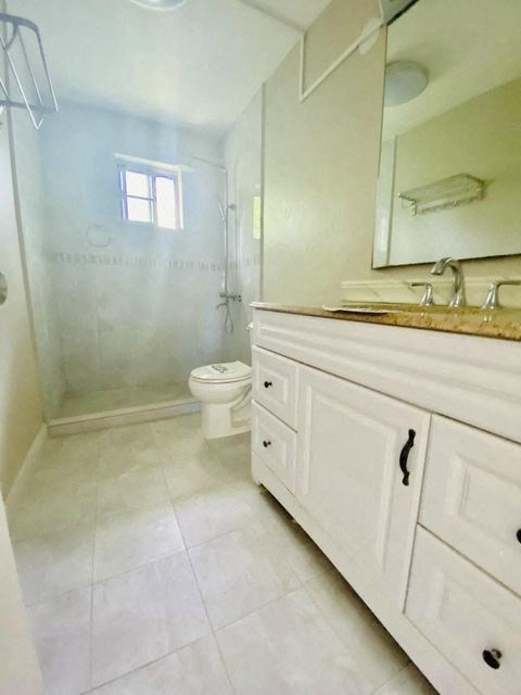 a bathroom with a toilet and a sink and a shower