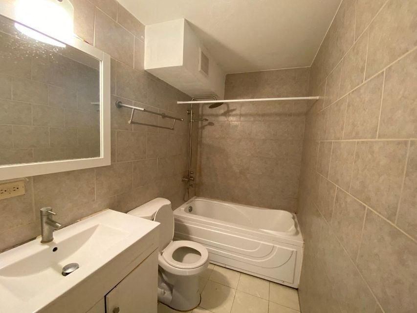 a bathroom with a toilet and a sink and a bath tub