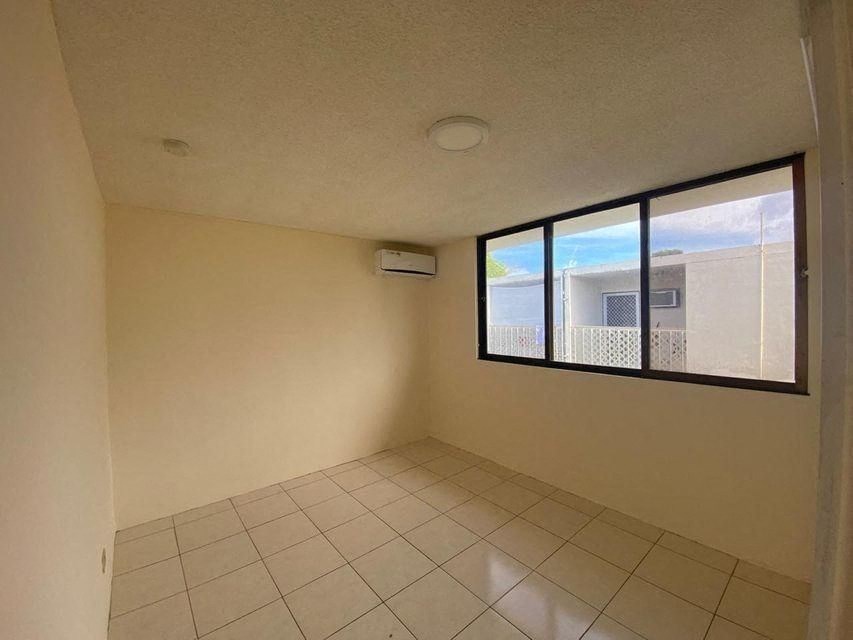 an empty room with a window and a tiled floor