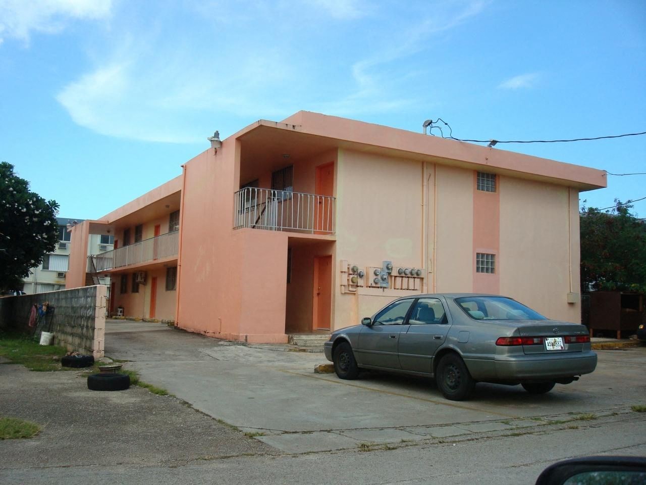 an apartment building with a car parked outside of it