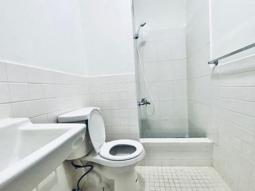 a white bathroom with a toilet and a sink
