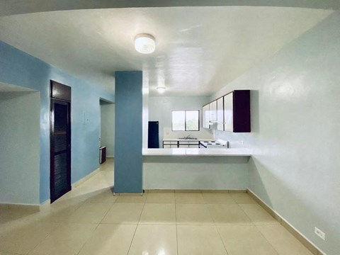 a large kitchen with a sink and a counter top