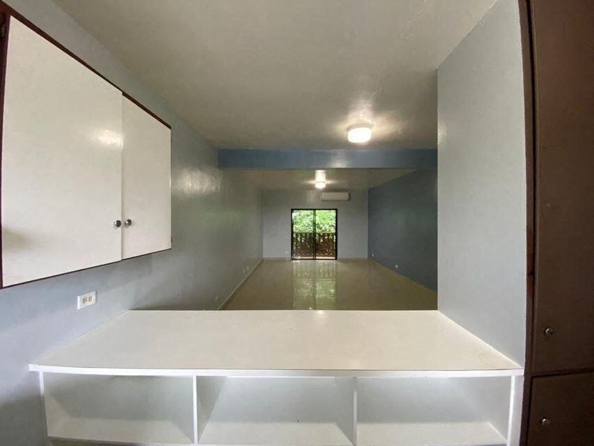 an empty room with a white counter in the middle
