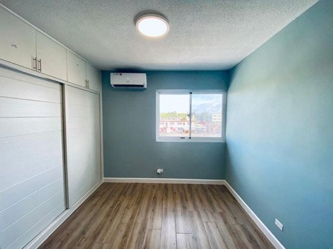 an empty room with blue walls and a window