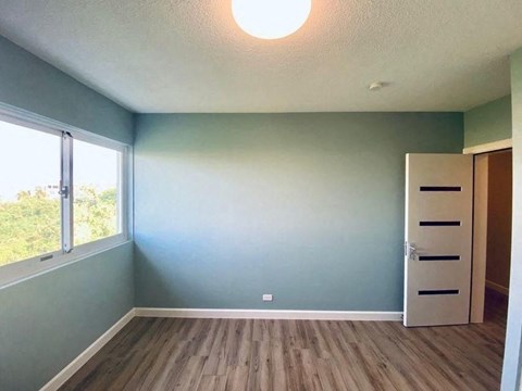 an empty room with blue walls and a closet