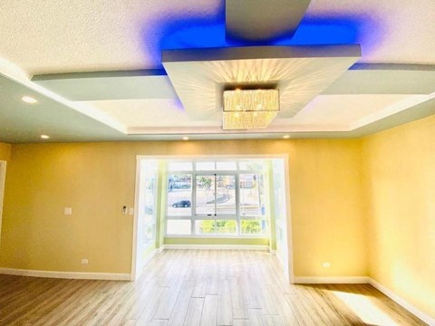 an empty room with a ceiling fan and a window