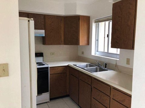 a kitchen with a sink a stove and a window