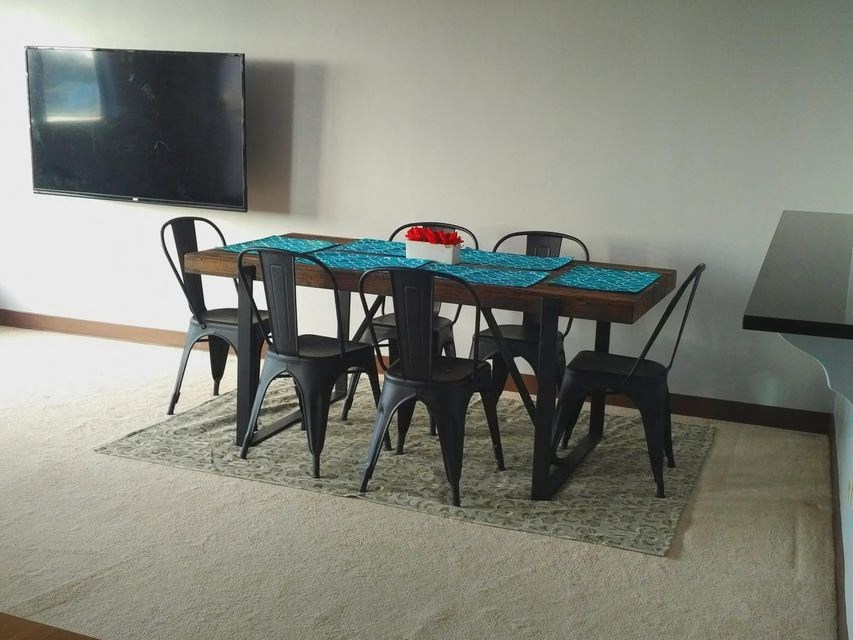 a dining room table and chairs on a rug