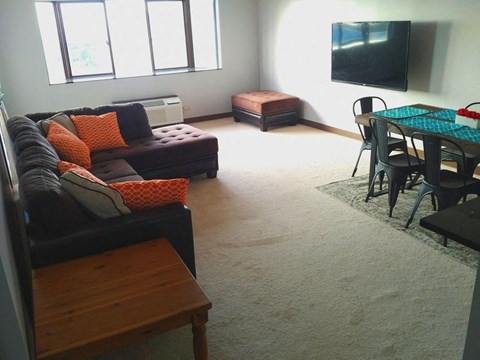 a living room with a couch and a dining room table