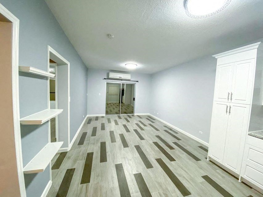 an empty room with a closet and a shower