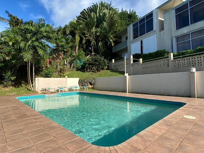 a swimming pool in front of a house