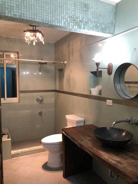 a bathroom with a toilet and a sink and a shower