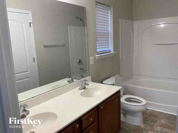 a bathroom with a sink and a toilet and a mirror