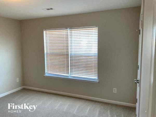 an empty room with a window and a door