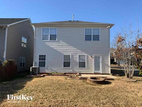 a white house with a yard in front of it