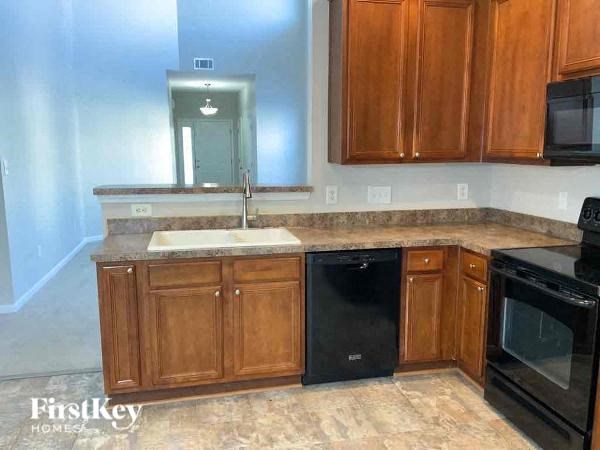 a kitchen with wooden cabinets and black appliances