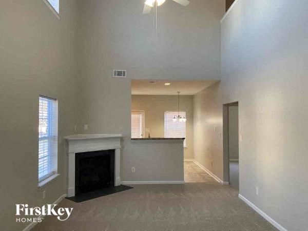 a large empty living room with a fireplace