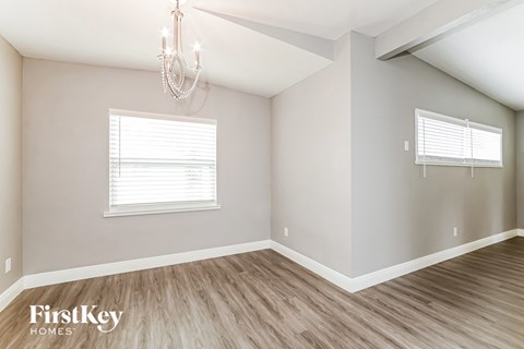 the living room of a new home with wood floors and a chandelier