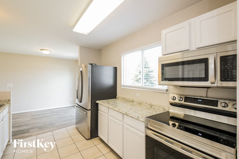 a kitchen with stainless steel appliances and white cabinets