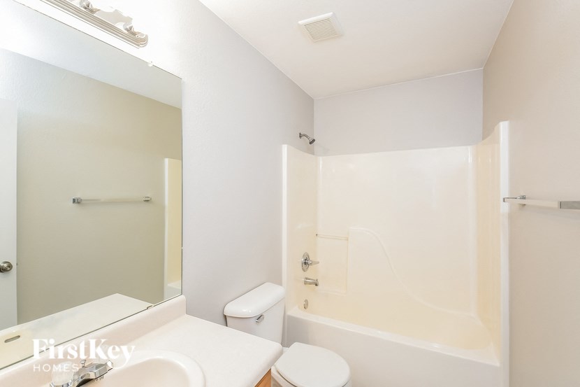 a bathroom with a shower toilet and sink and a mirror