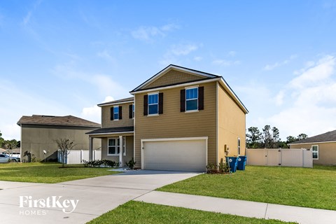 A two-story house with a garage is for sale.
