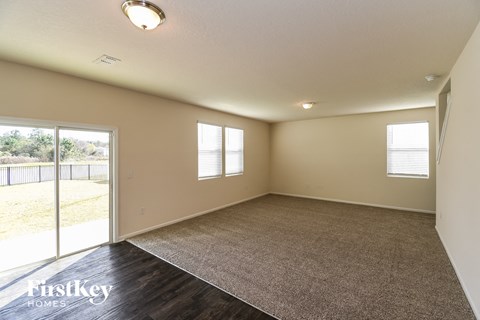 A room with a carpet floor and a window.