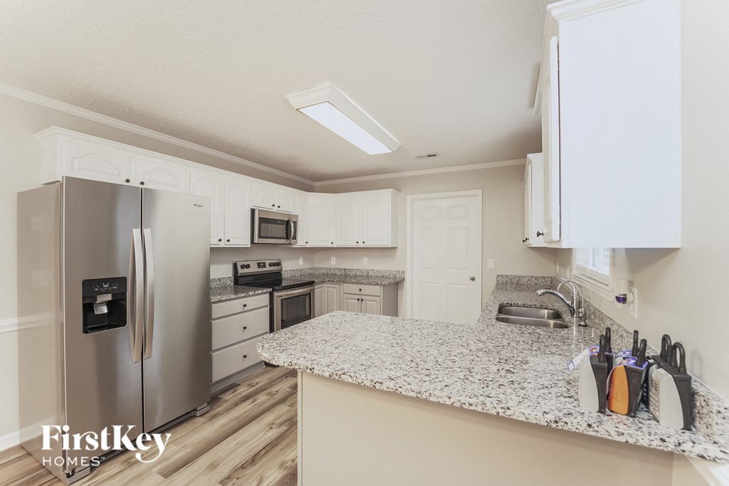 a kitchen with granite counter tops and stainless steel appliances