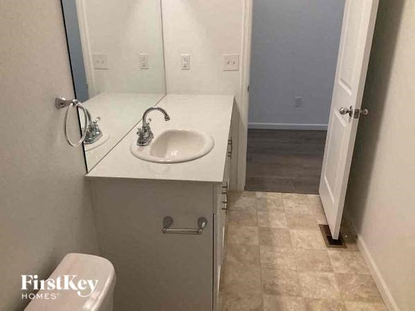 a small bathroom with a sink and a mirror