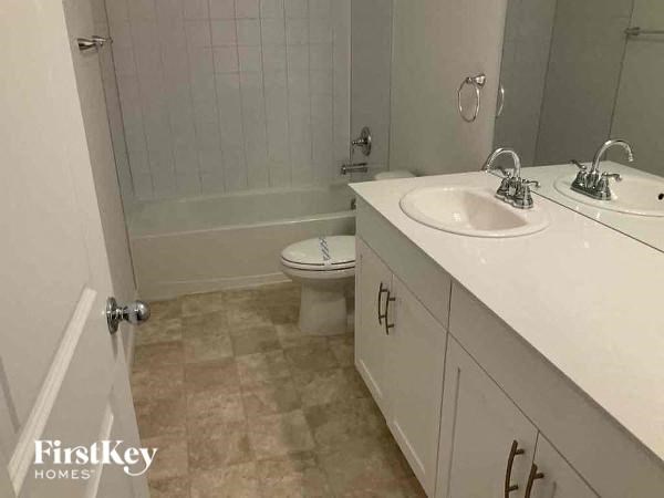 a bathroom with a sink and a toilet and a shower