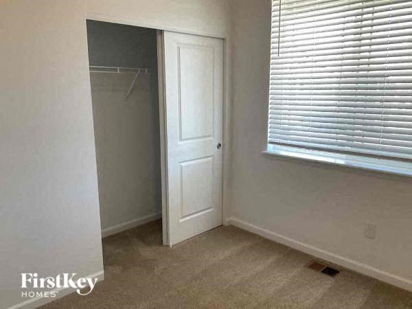 a room with a closet and a window and a door