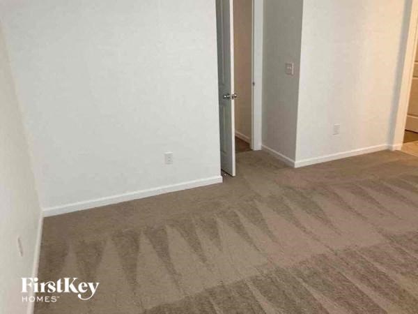an empty room with a wooden floor and a door