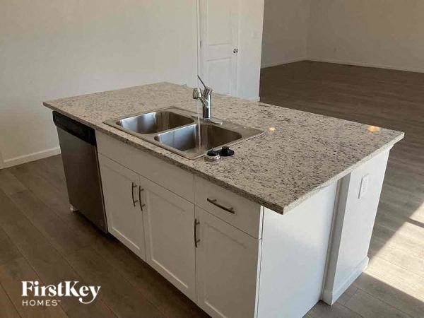 a kitchen with a sink and a counter top